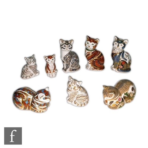 25 - Eight Royal Crown Derby Cat paperweights to include Fireside Cat, made exclusively for Peter Jones o... 