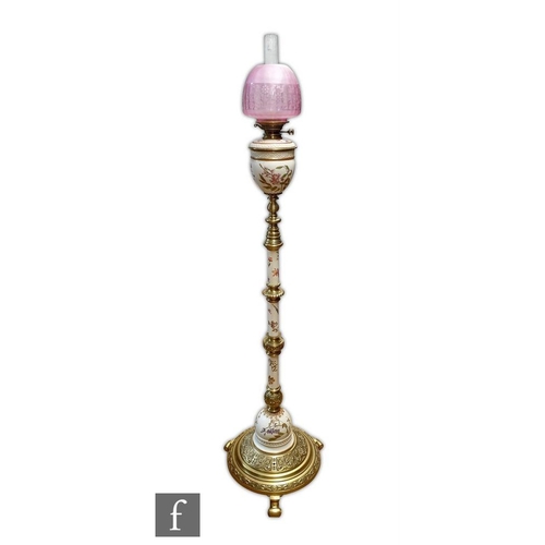 30 - A late 19th Century Royal Worcester blush ivory floor standing oil lamp, the reservoir with sprays o... 