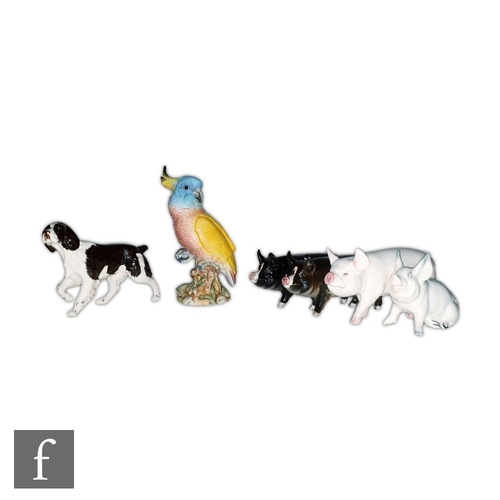 50 - A Beswick Cockatoo shape 1180, impressed and printed mark, together with four Beswick pigs and a Spa... 