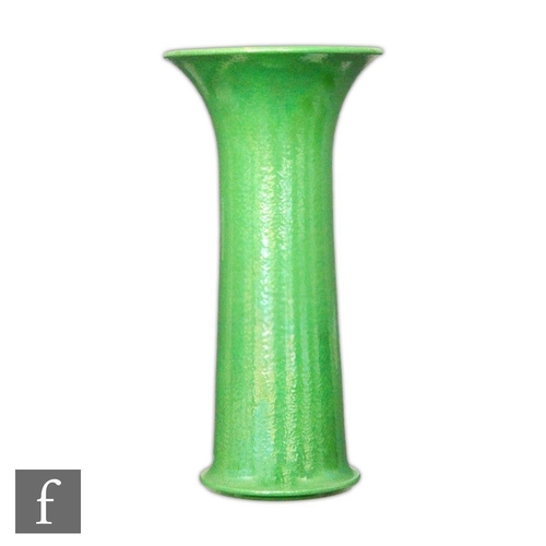 58 - A large Ruskin Pottery trumpet vase decorated in an all over apple green lustre, impressed mark, hei... 