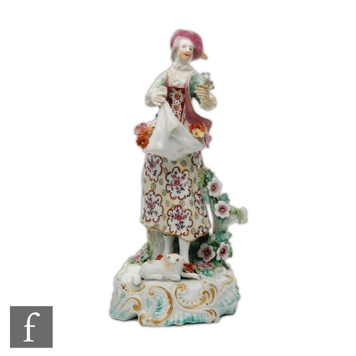 60 - A late 18th to early 19th Century Derby type model of a flower seller, stood on a rococo scroll base... 