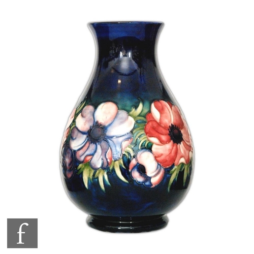 72 - A large William Moorcroft baluster vase decorated in the Anemone pattern with a band of flowers and ... 