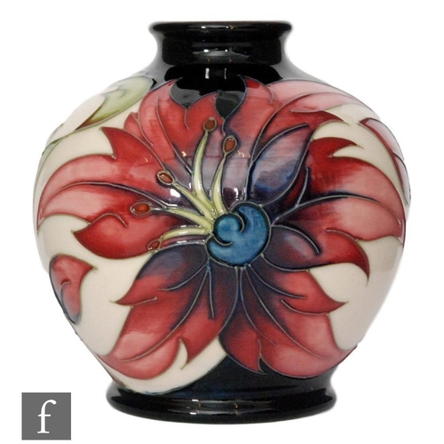 84 - A small Moorcroft Pottery limited edition vase of footed ovoid form with flared collar neck, decorat... 