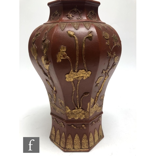 168 - A Chinese late Qing Dynasty (1644-1912) Yixing vase, the octagonal meiping vase relief moulded to th... 