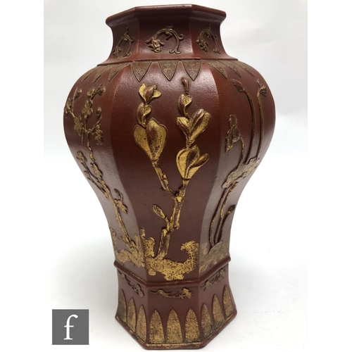 168 - A Chinese late Qing Dynasty (1644-1912) Yixing vase, the octagonal meiping vase relief moulded to th... 