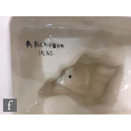 54 - A 1930s model of a lady walking her dog, stood before green foliage, all to a painted black pedestal... 