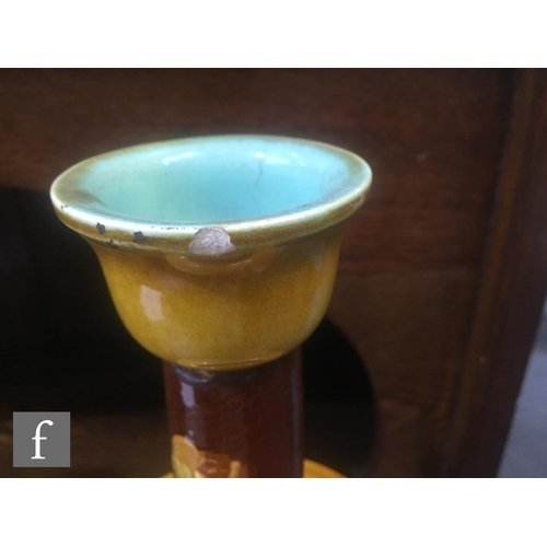 94 - A pair of late 19th Century Bretby Pottery vases, each of slender ovoid form, rising from a stepped ... 