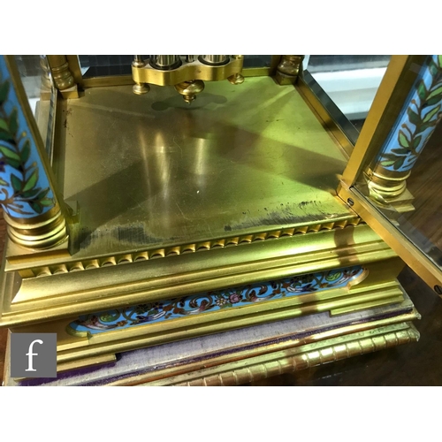 927 - A late 19th Century French ormolu and champleve enamel clock garniture, the four sided glass panel c... 