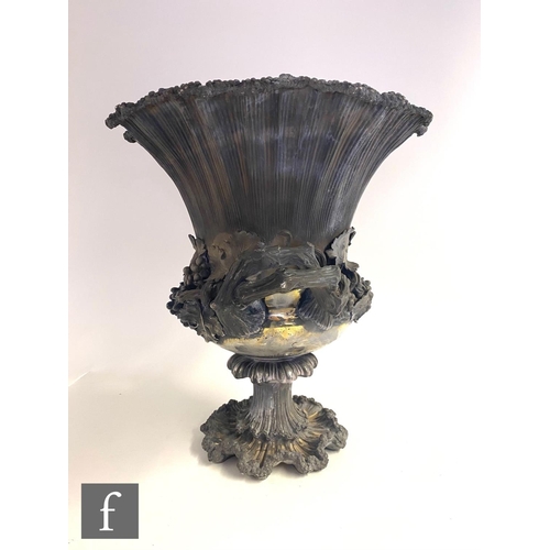 90 - A Georgian hallmarked silver campana urn shaped wine cooler shaped circular base below fruiting vine... 