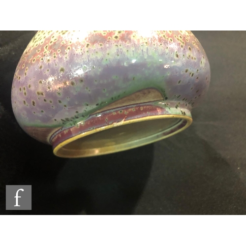 46 - Ruskin Pottery - A high fired vase of globe and flared shaft form decorated in a tonal lavender and ... 