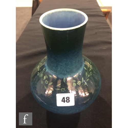 48 - Ruskin Pottery - A souffle glazed vase of angular form with a cylinder neck decorated in a mottled g... 