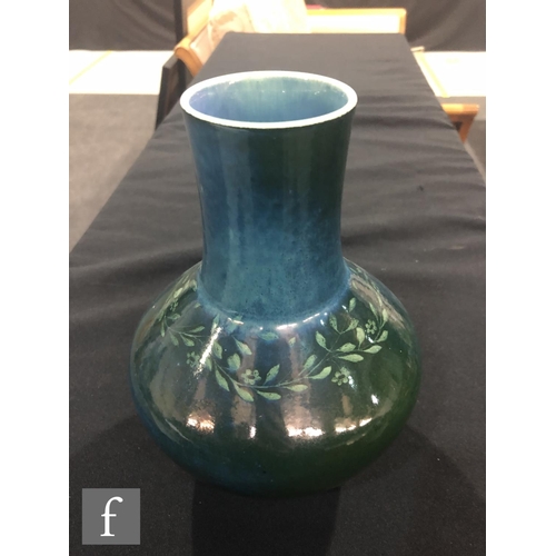 48 - Ruskin Pottery - A souffle glazed vase of angular form with a cylinder neck decorated in a mottled g... 