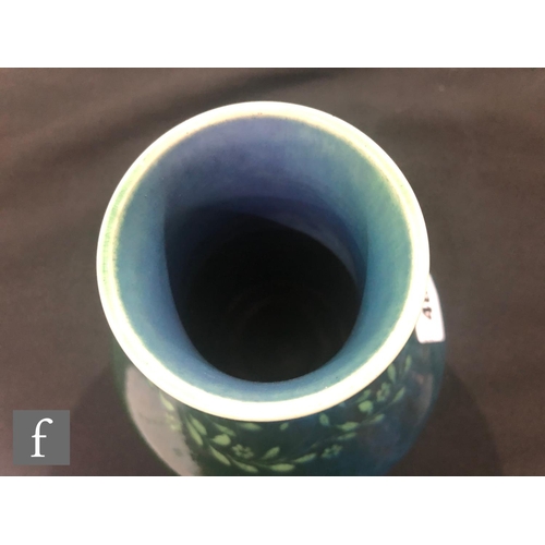 48 - Ruskin Pottery - A souffle glazed vase of angular form with a cylinder neck decorated in a mottled g... 