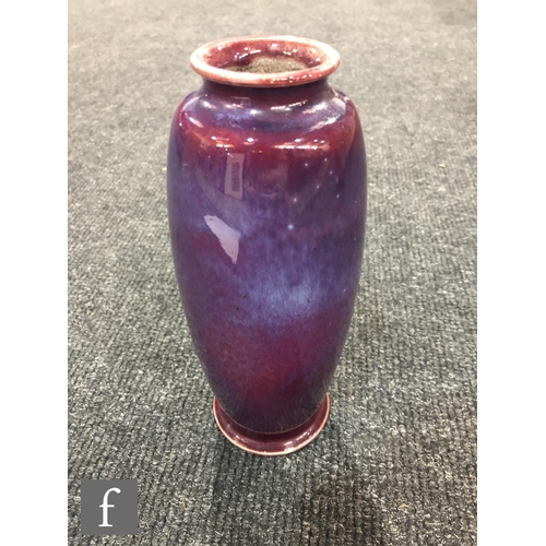 45 - Ruskin Pottery - A high fired vase of swollen form with a roll rim and slight flared foot decorated ... 