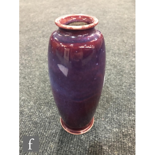 45 - Ruskin Pottery - A high fired vase of swollen form with a roll rim and slight flared foot decorated ... 