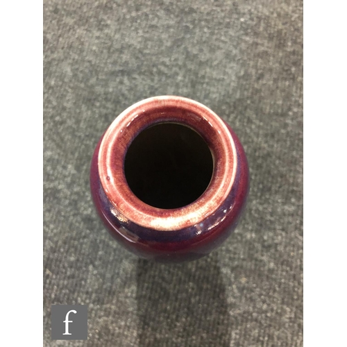 45 - Ruskin Pottery - A high fired vase of swollen form with a roll rim and slight flared foot decorated ... 