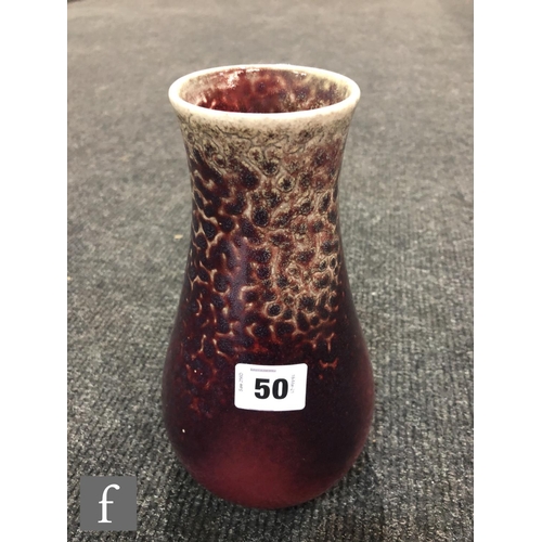 50 - Ruskin Pottery - A high fired vase of tapering form decorated in a Sang de Beouf with light fissurin... 
