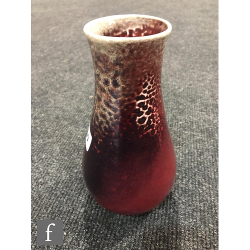 50 - Ruskin Pottery - A high fired vase of tapering form decorated in a Sang de Beouf with light fissurin... 