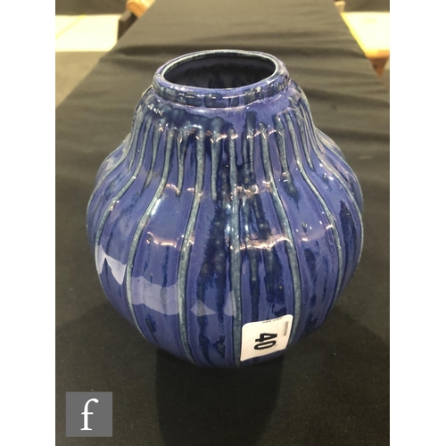 40 - Doulton Lambeth - An early 20th Century vase of gourd form, the whole decorated in a streaked blue g... 