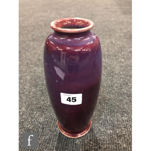 45 - Ruskin Pottery - A high fired vase of swollen form with a roll rim and slight flared foot decorated ... 