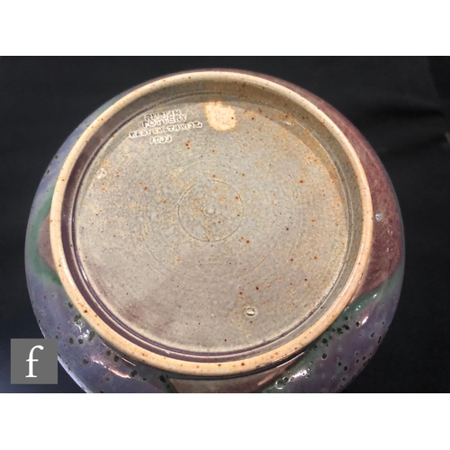 46 - Ruskin Pottery - A high fired vase of globe and flared shaft form decorated in a tonal lavender and ... 