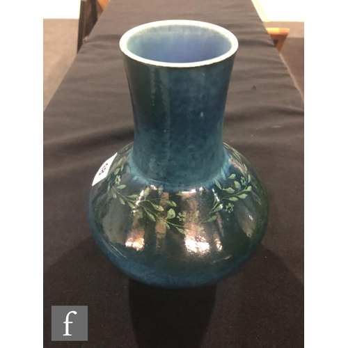 48 - Ruskin Pottery - A souffle glazed vase of angular form with a cylinder neck decorated in a mottled g... 