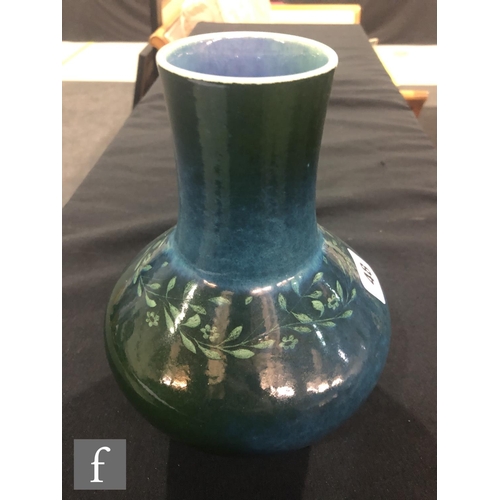48 - Ruskin Pottery - A souffle glazed vase of angular form with a cylinder neck decorated in a mottled g... 