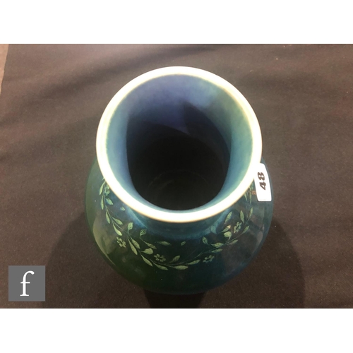 48 - Ruskin Pottery - A souffle glazed vase of angular form with a cylinder neck decorated in a mottled g... 