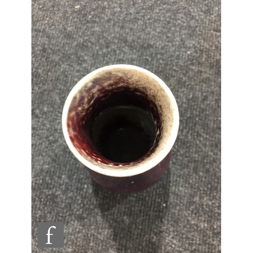 50 - Ruskin Pottery - A high fired vase of tapering form decorated in a Sang de Beouf with light fissurin... 