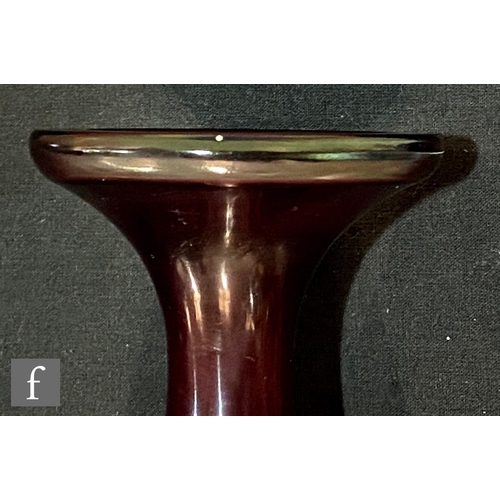 6 - Galle - An early 20th Century cameo glass vase of footed swollen form, cased in ruby over a graduate... 