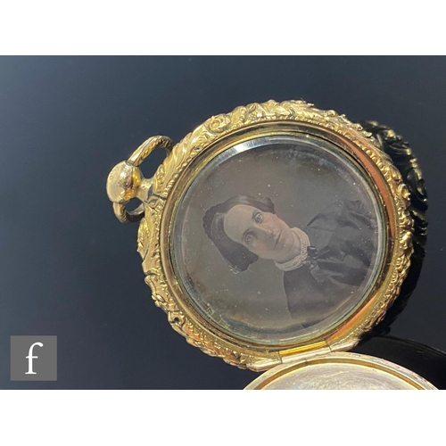 526 - A 19th Century 9ct double sided circular locket with a portrait daguerreotype of a man to one side a... 