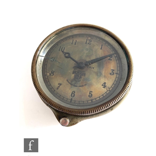 709 - A 20th Century Smiths car dashboard clock, Arabic numerals to a brass dial, case diameter 9.5cm.