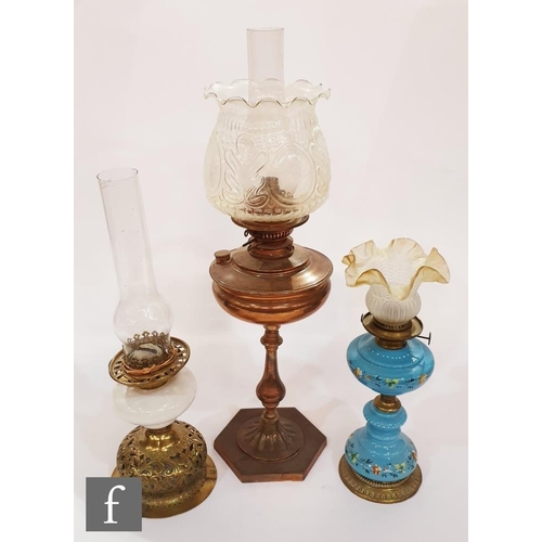 757 - A collection of three late 19th to early 20th Century oil lamps, to include a blue opaline glass exa... 