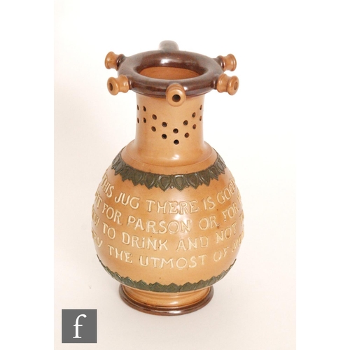 79 - A late 19th Century Royal Doulton stoneware puzzle jug, the body with tubelined motto 'Within this j... 