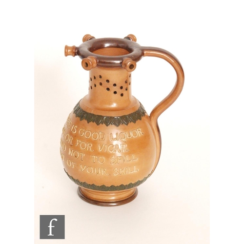 79 - A late 19th Century Royal Doulton stoneware puzzle jug, the body with tubelined motto 'Within this j... 