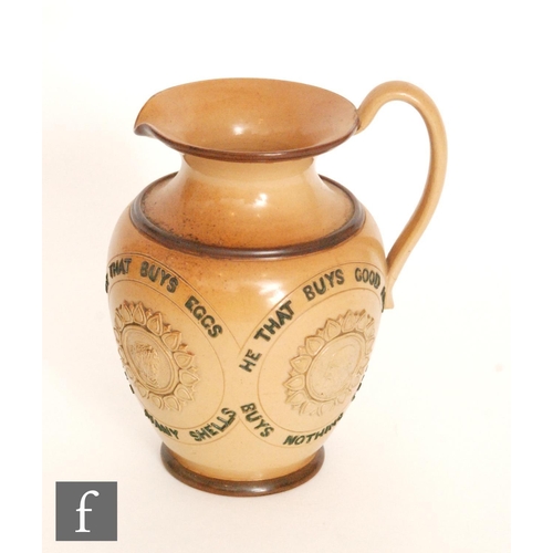 82 - An early 20th Century Doulton Lambeth stoneware motto jug decorated to the body with the motto 'He t... 