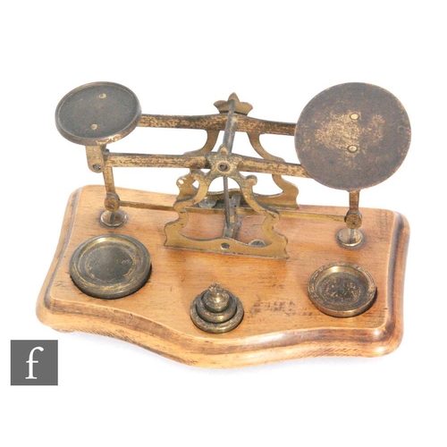 738 - A set of Victorian brass letter scales with graduated set of brass weights, width 18cm.