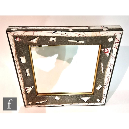 765 - A circa 1986 wall mirror of square section with deep swept frame hand decorated with abstract motifs... 