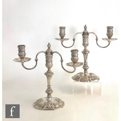 496 - A pair of hallmarked silver cast squat twin light candelabrum, shaped octagonal bases with mask and ... 