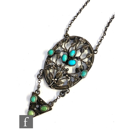 552 - An Arts and Crafts silver pierced oval pendant decorated with leaves and berries highlighted with tu... 