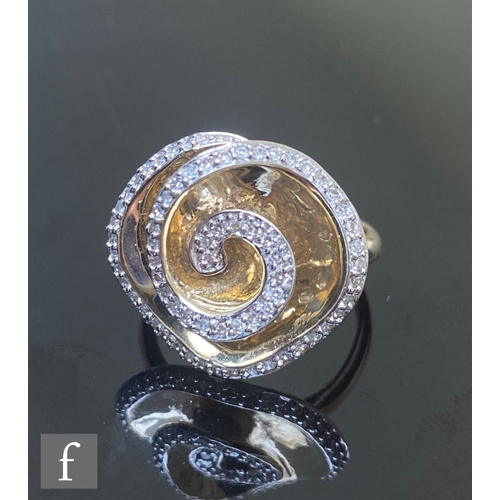 605 - A 9ct hallmarked diamond set ring with a spiral of individually set stones to a shaped square head, ... 