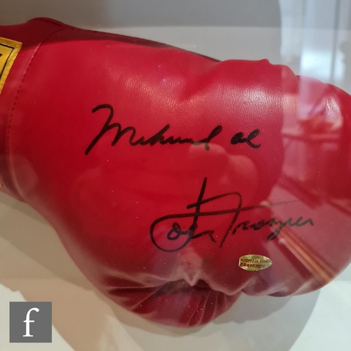 766 - A framed Everlast boxing glove bears a signature reputedly by Muhammad Ali and Joe Frazier, with cer... 