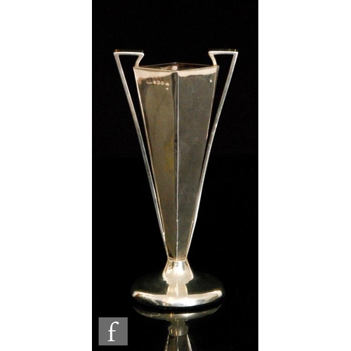 173 - A hallmarked silver bud vase of footed form with flared diamond form body and applied twin angular h... 