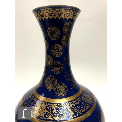 194 - A Chinese Guangxu (1875-1908) powder-blue bottle vase, rising from a high footring, the flecked rich... 