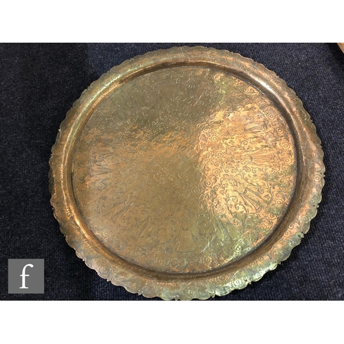 207 - A collection Middle Eastern/Persian brass trays,  to include two plain rimmed examples, with foliate... 