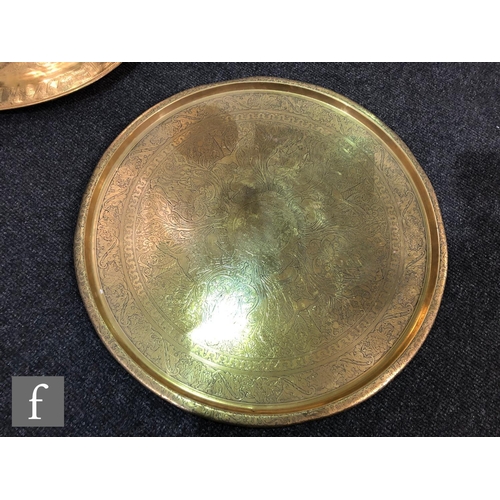 207 - A collection Middle Eastern/Persian brass trays,  to include two plain rimmed examples, with foliate... 