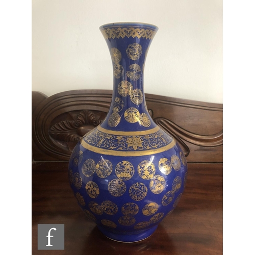 194 - A Chinese Guangxu (1875-1908) powder-blue bottle vase, rising from a high footring, the flecked rich... 