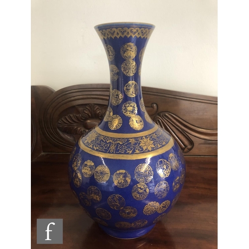 194 - A Chinese Guangxu (1875-1908) powder-blue bottle vase, rising from a high footring, the flecked rich... 