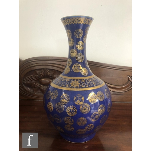 194 - A Chinese Guangxu (1875-1908) powder-blue bottle vase, rising from a high footring, the flecked rich... 