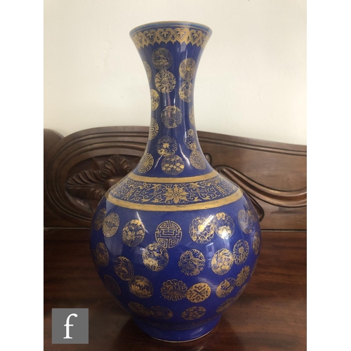 194 - A Chinese Guangxu (1875-1908) powder-blue bottle vase, rising from a high footring, the flecked rich... 